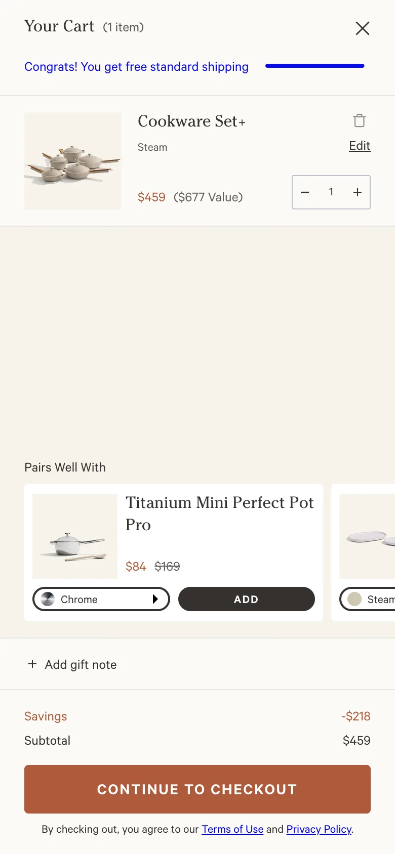 Our Place slide-out cart drawer with a cleared free-shipping bar and the Pairs Well With cross-sell carousel leading with the $84 Titanium Mini Perfect Pot Pro